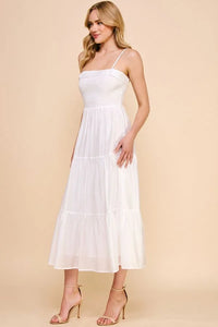 White sleeveless soft tiered maxi dress with smocked bodice and flowy skirt