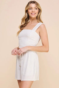 White sleeveless mini dress with square neckline and textured fabric, perfect for pinstriped soft linen style