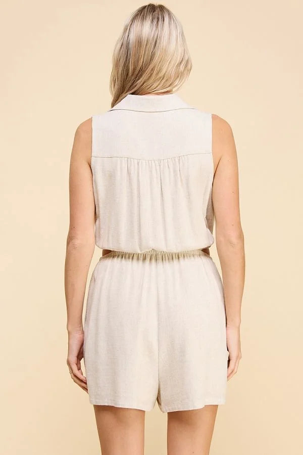 White sleeveless collared button front romper with gathered waist worn from behind