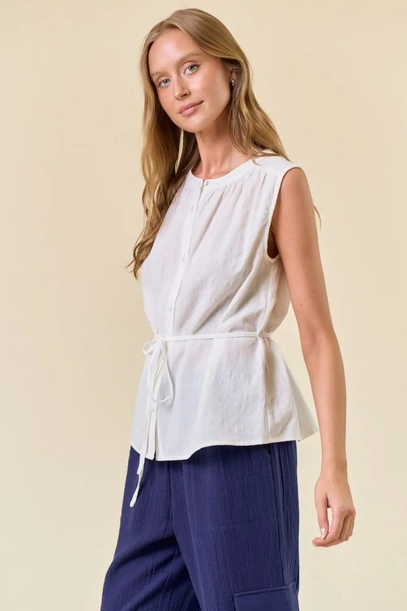 White sleeveless tie-waist blouse from women’s boho chic clothing by Shop Daisy
