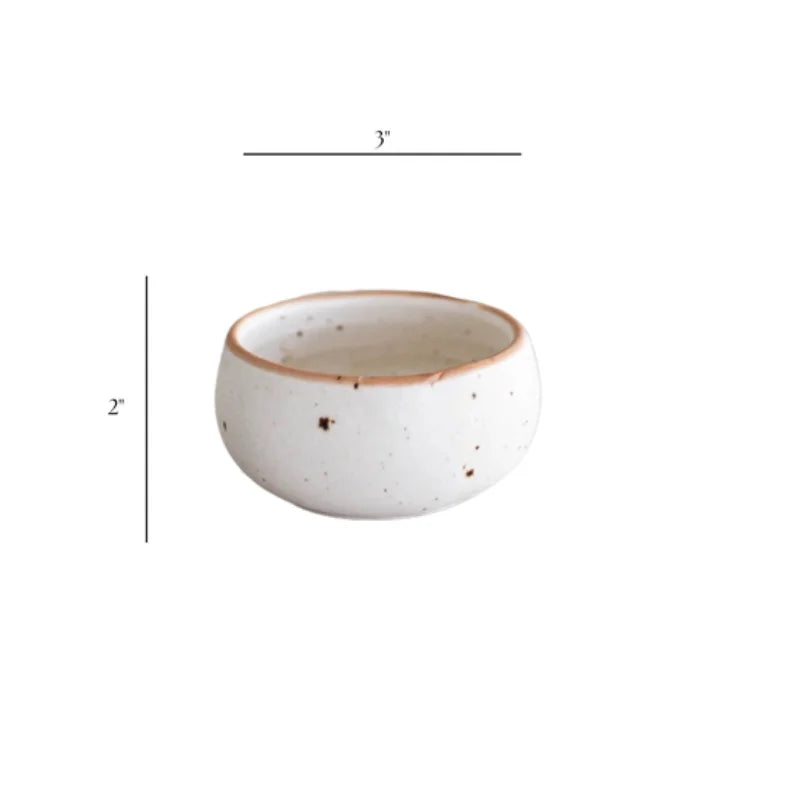White speckled ceramic dip bowl with brown rim and handleless design