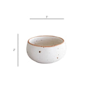 White speckled ceramic dip bowl with brown rim and handleless design