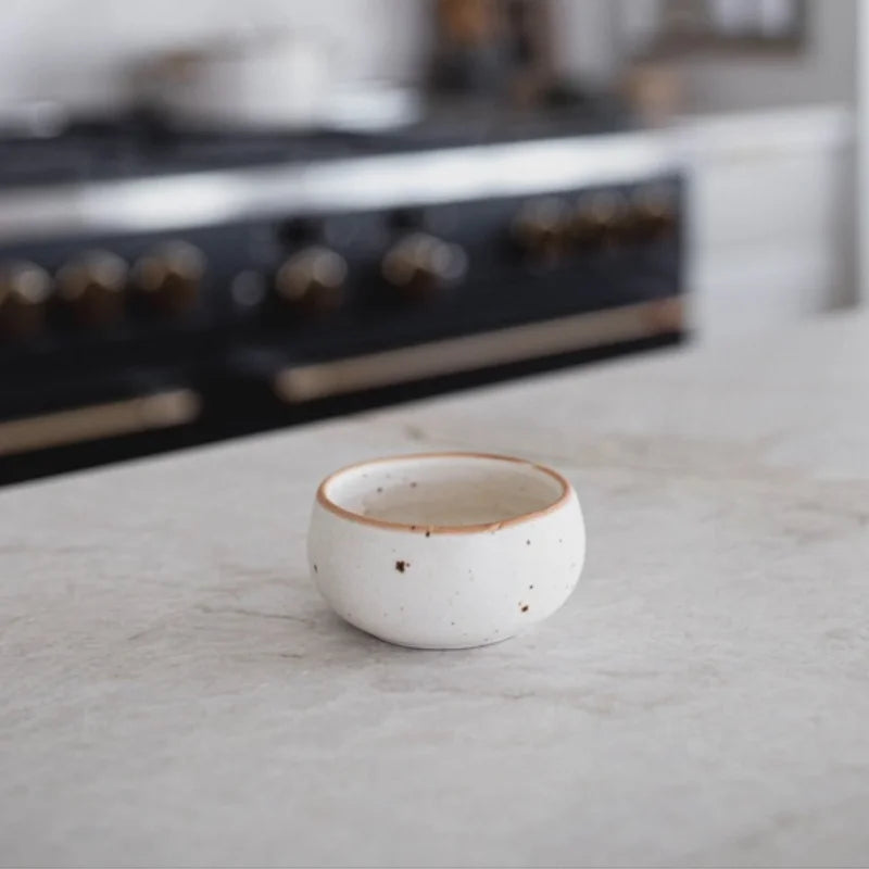 Modern ceramic white speckled dip bowl with brown rim and handle