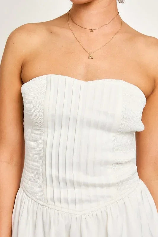 White strapless smocked bodice tube dress featuring vertical pleats on the bodice