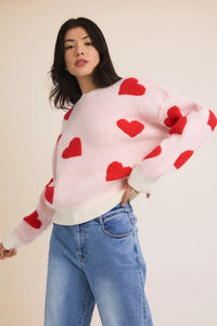 White sweater with red heart appliques and blue jeans for women’s boho chic clothing