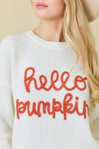 White crew neck sweater featuring hello pumpkin in orange lettering on front