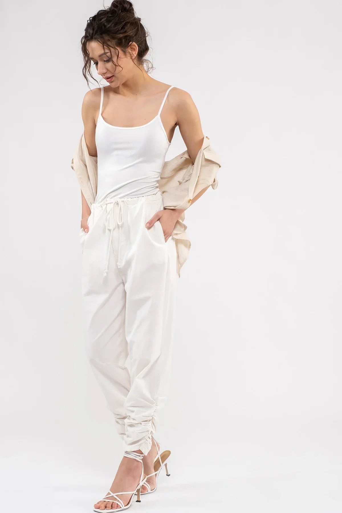 White drawstring sweatpants with SOLID SPAGHETTI STRAP TANK TOP and light cardigan outfit