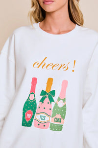 White Cheers graphic sweatshirt featuring a vibrant Cheers! design with champagne bottles