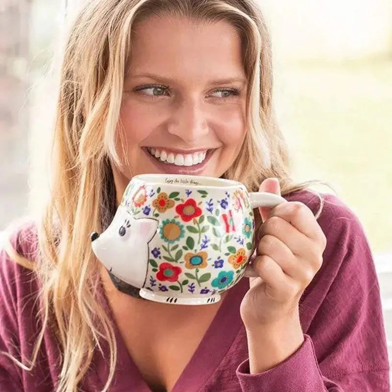 White floral teapot in HEDGEHOG FOLK ART COFFEE MUG, perfect for women’s boho chic clothing