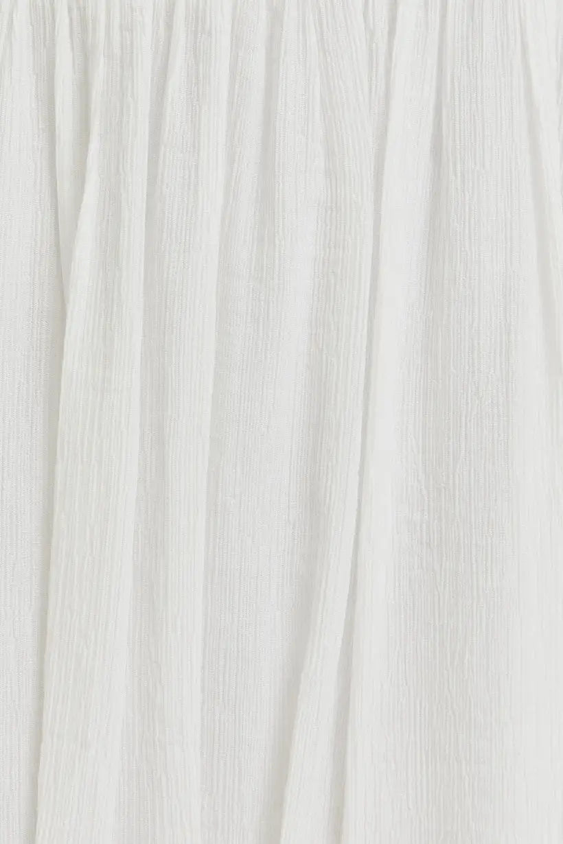 White textured fabric with vertical folds for smocked spaghetti strap crop top from Daisy Lane Offers