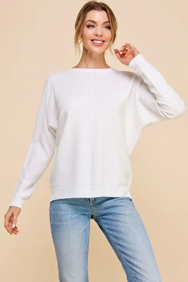 White textured knit sweater with long sleeves showcasing soft mixed texture and boat neckline