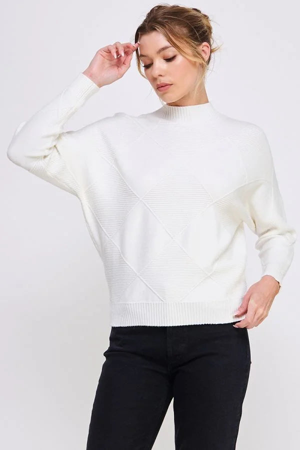 White turtleneck sweater showcased by a woman in a soft long sleeve dolman mock neck style