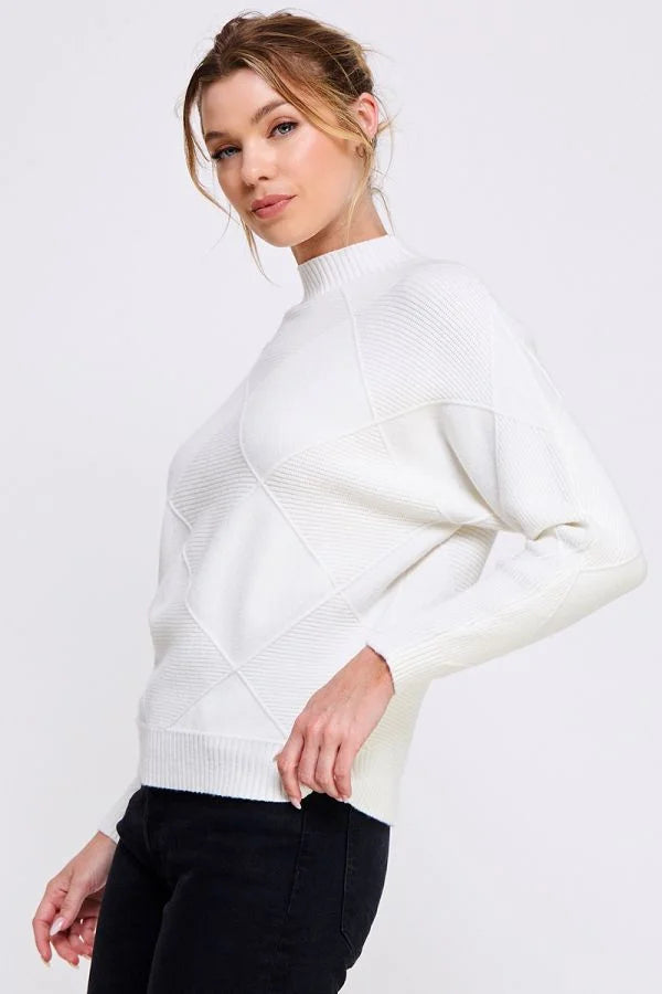 White turtleneck sweater worn by a woman, featuring a soft long sleeve dolman design