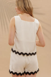 White two-piece set with black wavy contrast hem, ideal for summer fashion