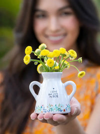 White vase with yellow flowers in ARTISAN BUD VASE - MOM, perfect for women’s boho chic clothing