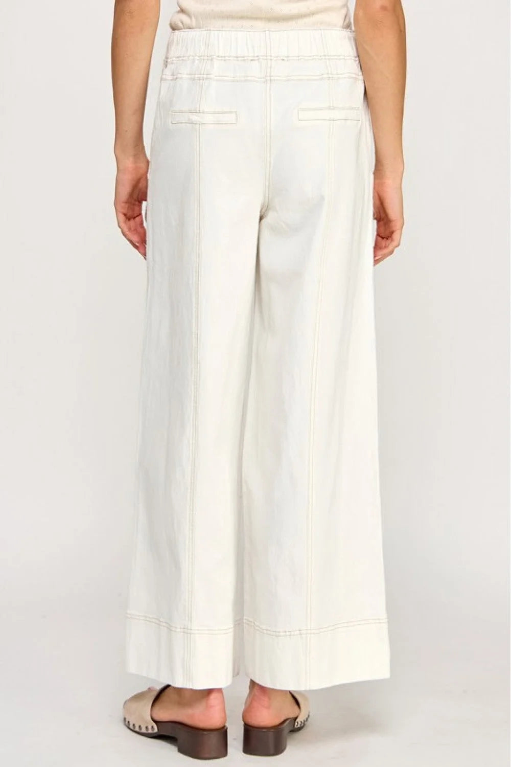 White wide-leg linen pants with pockets and high waistband