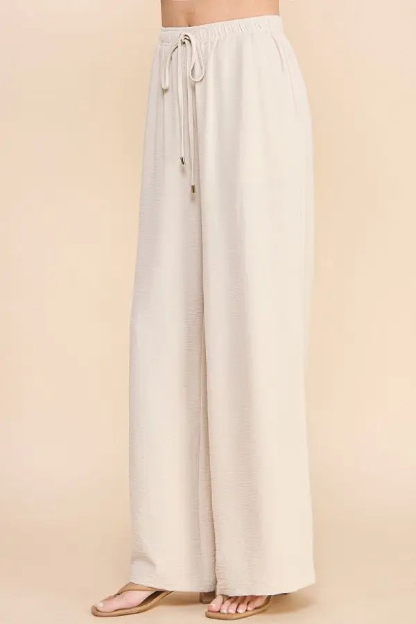 White wide-leg AIRY DRAWSTRING PANTS with pockets and drawstring waist for comfort