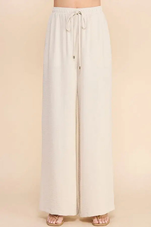 White wide-leg AIRY DRAWSTRING PANTS with pockets and drawstring waist for comfort