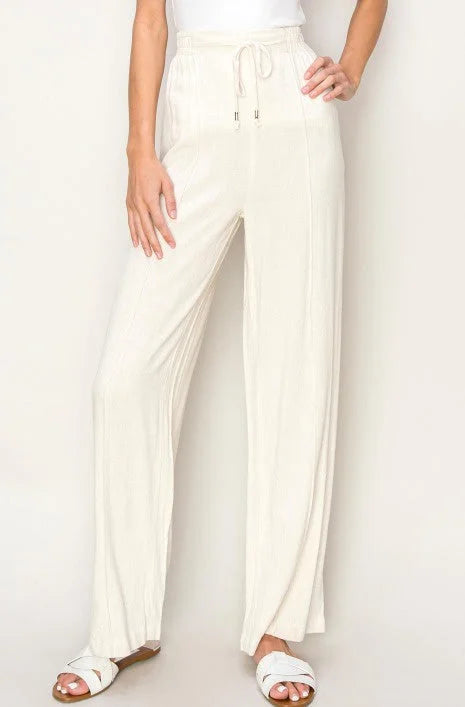 White woven textured wide leg pants with a drawstring waist for stylish comfort