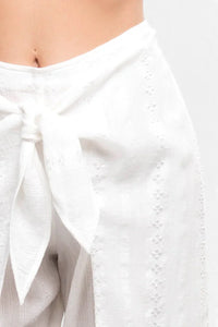 White flowy wrap skirt with a tied knot at the waist for a boho free spirit style