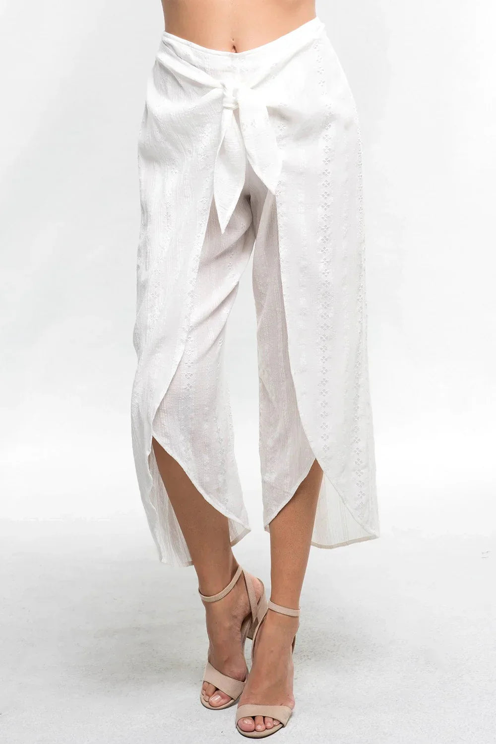 White wrap-style skirt with front tie and asymmetrical hem, perfect for a boho free spirit