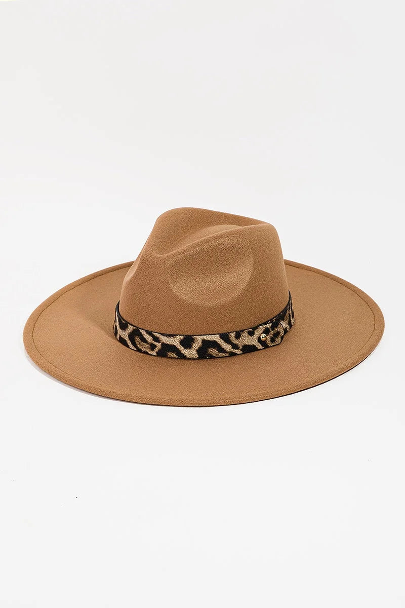 Wide-brimmed tan fedora with leopard print band, ideal for boho chic womens clothing