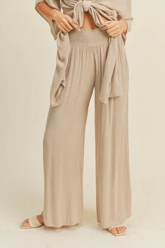 Wide-leg beige rayon smocked waist pants with a high waistband and pleated front