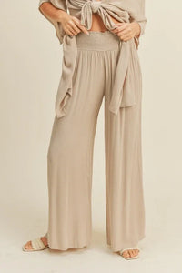 Wide-leg beige rayon smocked waist pants with a high waistband and pleated front