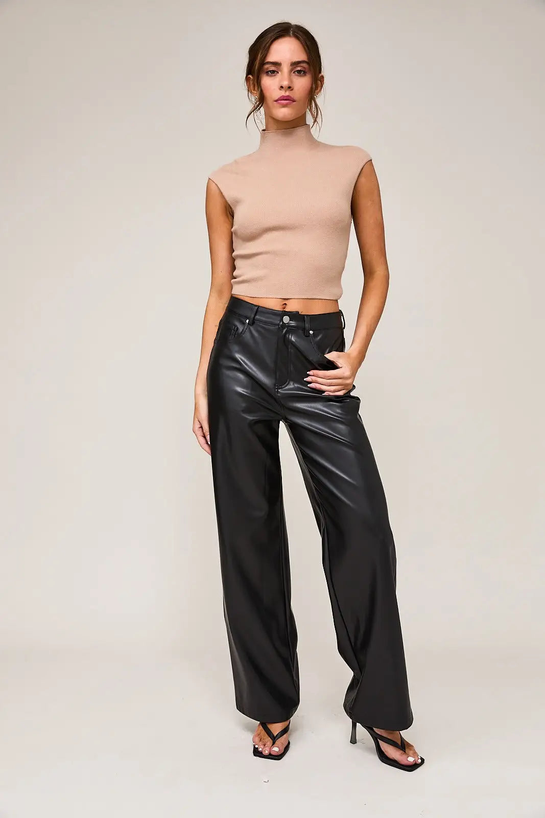 High waist faux leather long pants styled with a beige crop top for a chic look