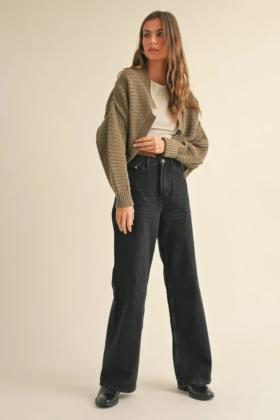 Wide-leg dark denim jeans with chunky olive cardigan and cream sweater in women’s boho chic clothing