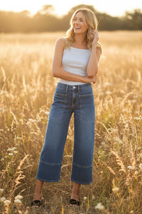 High rise cropped wide leg denim jeans in light blue wash with distressed details