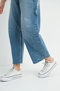 Wide-leg denim jeans paired with white platform sneakers for a stylish look