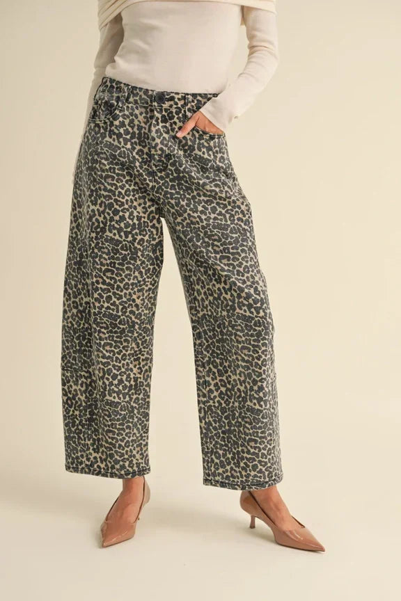 Wide-leg leopard print barrel pants styled with brown kitten heels for a chic look