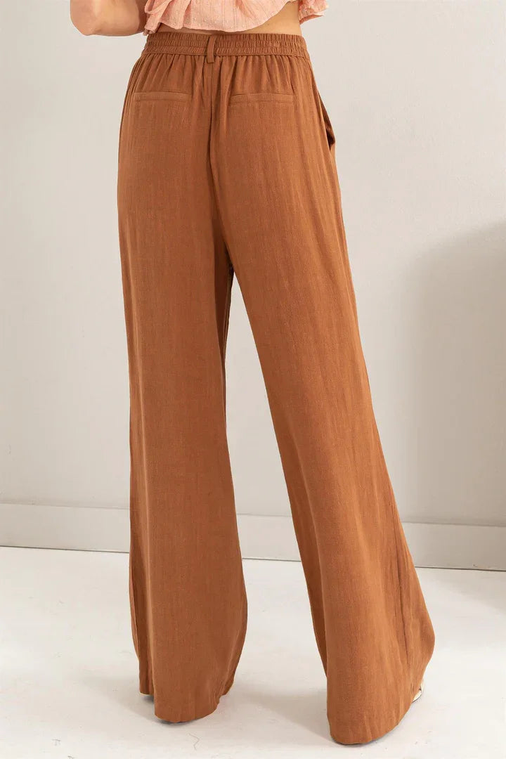 Linen blend pleated wide leg pants in warm caramel color with elastic waistband