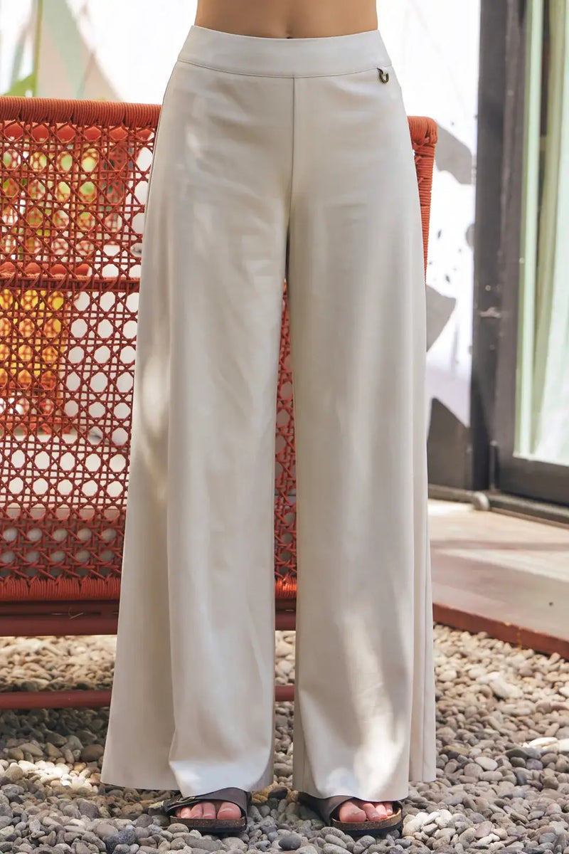 Off-white suede wide leg pants showcased in a stylish fashion setting