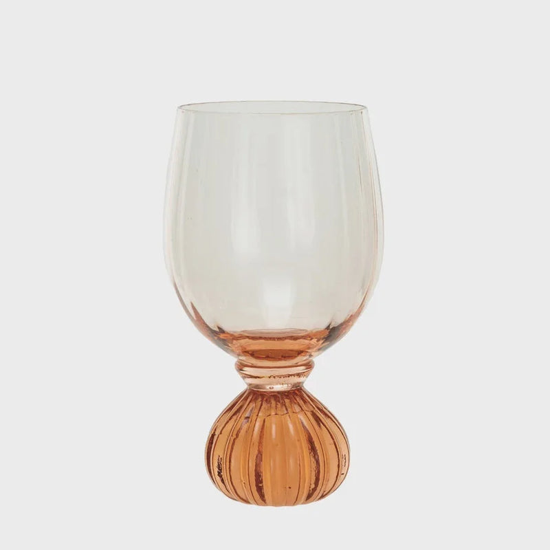 Ribbed Footed Wine Glass featuring a ribbed amber base and clear bowl for elegant serving