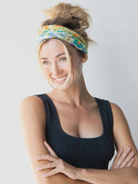 Woman smiling with arms crossed wearing a vibrant Boho Bandeau headband