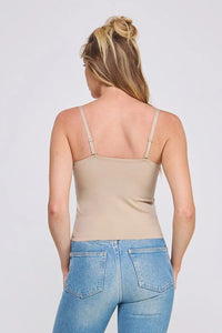 Woman wearing a beige bralette cami and blue jeans, perfect for women’s boho chic clothing from Shop Daisy