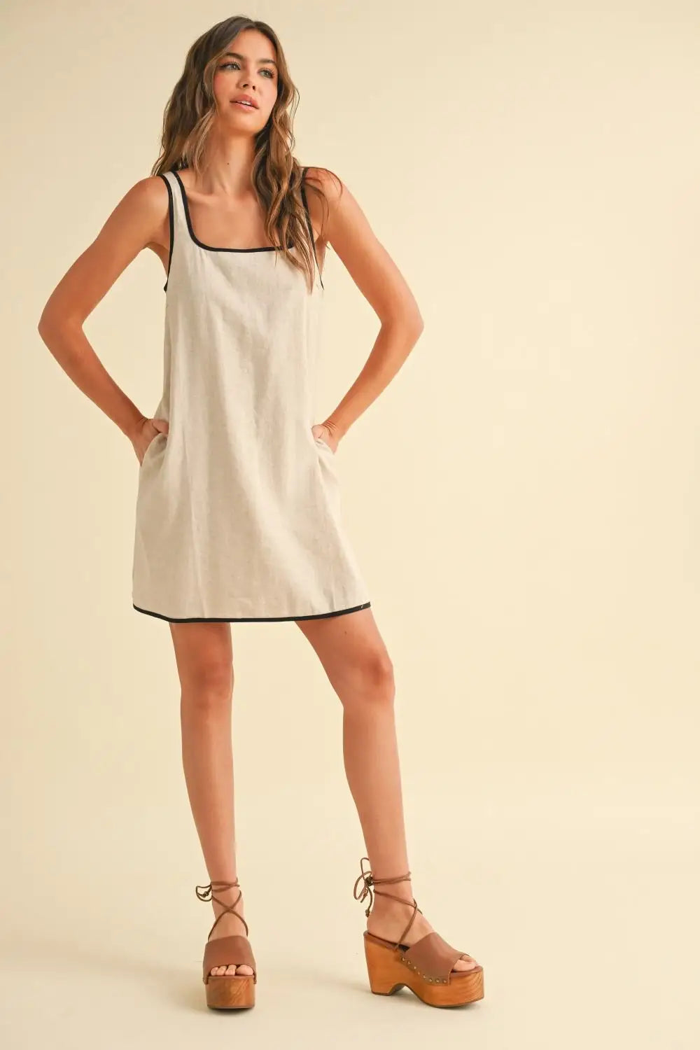 Women’s boho chic clothing: beige linen sleeveless piping detail dress with platform sandals