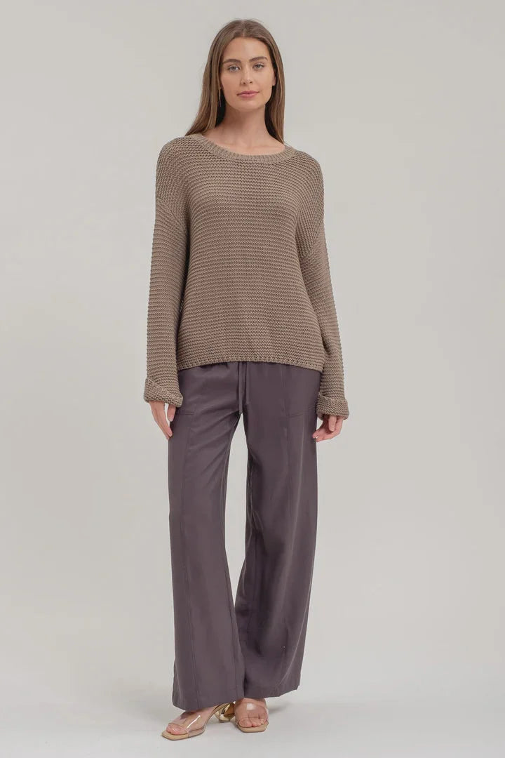 Woman styled in a Chunky Knit Long Sleeve Pullover Sweater and wide-leg gray pants