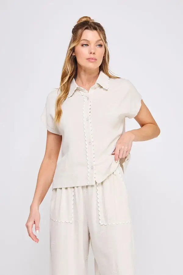 Woman wearing a COLLARED BOW LINEN BUTTON DOWN SHIRT and matching linen pants