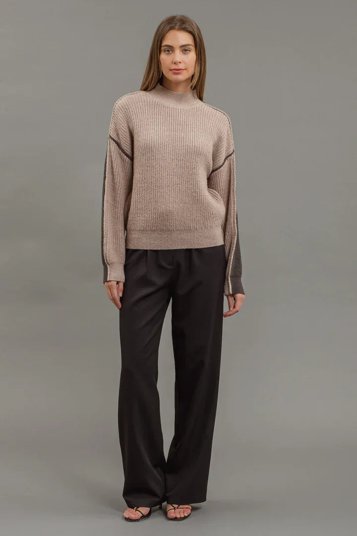 Woman in beige Colorblock Mock Neck Knit Sweater and dark wide-leg pants