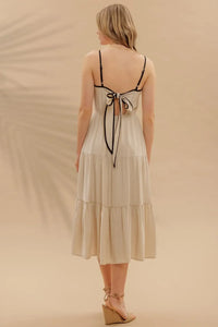 Woman in beige tiered midi sundress showcasing women’s boho chic clothing at Shop Daisy