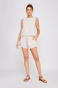 Woman wearing an elegant sleeveless tulip top with crochet lace trim for effortless summer wear