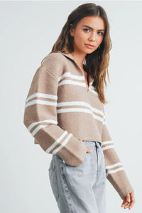 Woman wearing beige and white stripe crop collar sweater top with light wash jeans