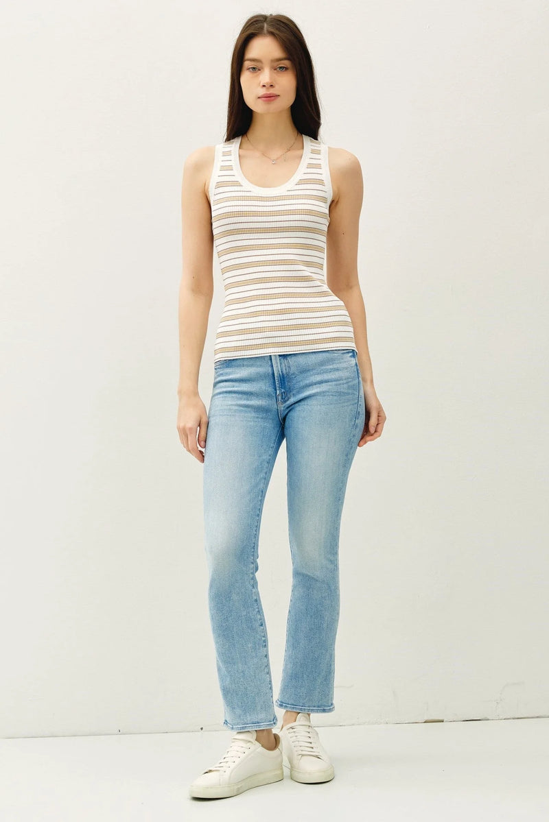 Woman wearing stripe ribbed knit tank top with light blue jeans and white sneakers