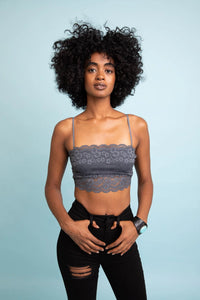 Woman with large afro hair showcasing a wide lace bandeau with detachable straps