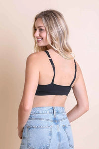 Woman in black padded ribbed keyhole front bralette and denim shorts showcasing style