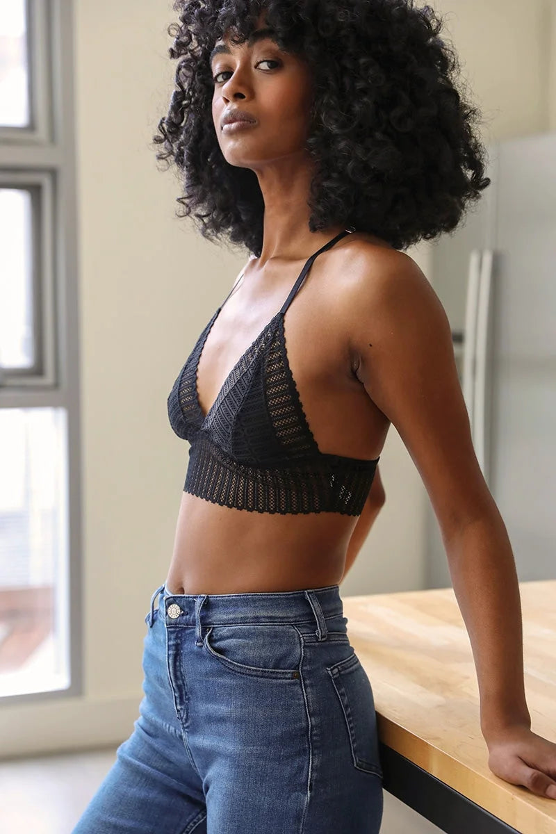 Woman wearing a Ribbed Lace Boho Racerback Bralette with jeans, showcasing stylish comfort