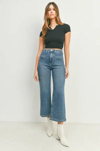 Woman in black crop top and white boots showcasing women’s boho chic sailor pocket wide leg jeans